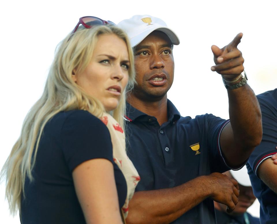 U.S. golfer Tiger Woods talks with his girlfriend Lindsey Vonn after winning his first round match during the opening Four-ball matches for the 2013 Presidents Cup golf tournament at Muirfield Village Golf Club in Dublin, Ohio October 3, 2013. REUTERS/Chris Keane (UNITED STATES - Tags: SPORT GOLF)