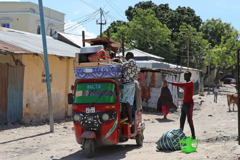 Residents load their belongings into rickshaws as they flee, in Hodan district of Mogadishu