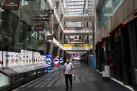 A worker walks by a stretch of closed restaurants inside the Pavilion shopping mall on 18 March 2020, the first day of the Movement Control Order. (PHOTO: Fadza Ishak for Yahoo Malaysia)