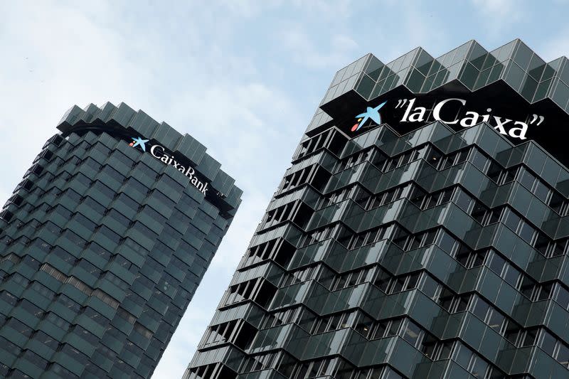 CaixaBank's logo is seen on top of the company's headquarters in Barcelona