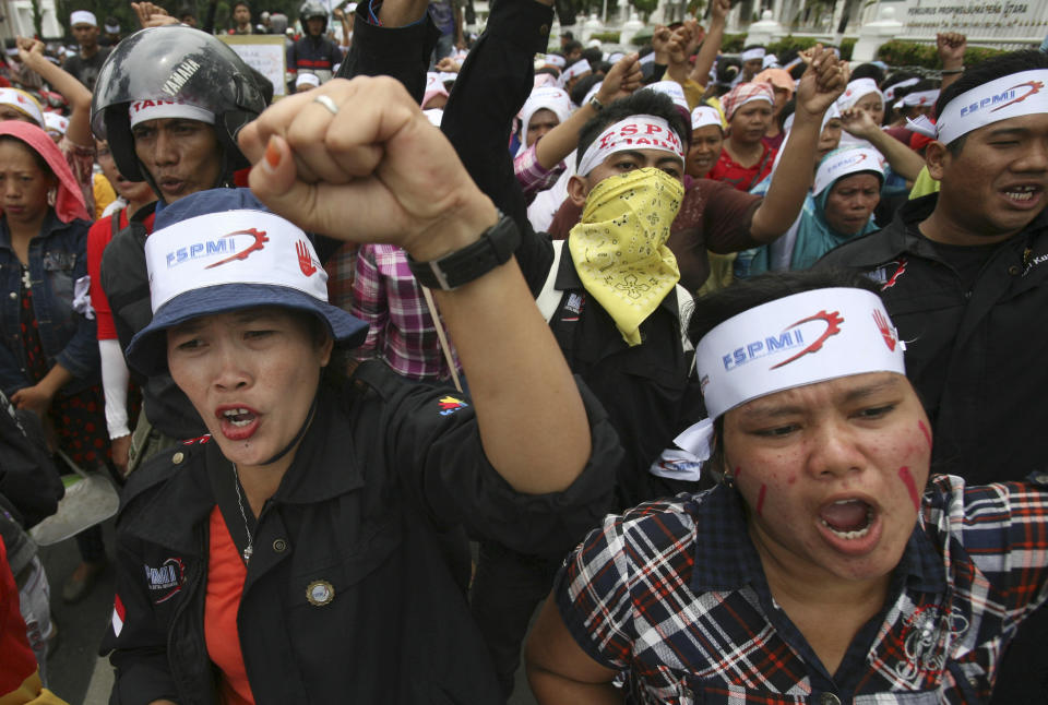 Factory workers shout slogans during a protest in medan, North Sumatra, Indonesia, Wednesday, Oct. 3, 2012. Indonesian unions said more than 2 million factory workers have gone on a one-day strike across the country to call for higher wages and protest the hiring of contract workers. (AP Photo/Binsar Bakkara)