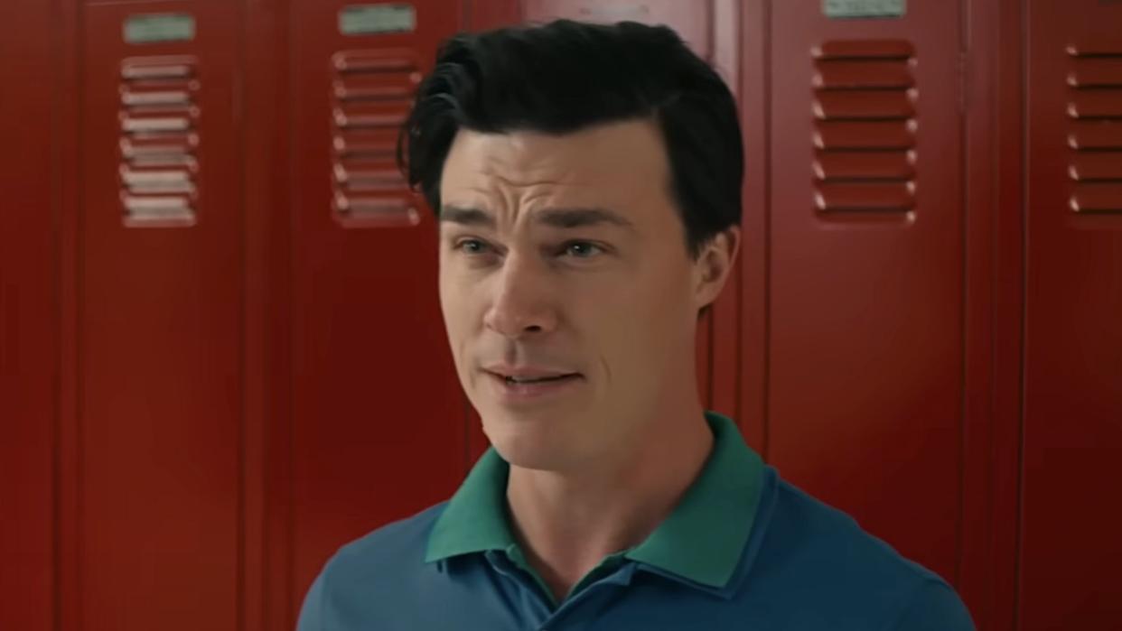  Finn Wittrock's Coach Laidlow standing in front of red lockers in Downtown Owl. 