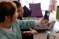 Zhang Shiyu, a 18-year-old student majoring in esports and management, talks to her parents via phone in Chengdu, Sichuan province, China, November 19, 2017. EUTERS/Tyrone Siu