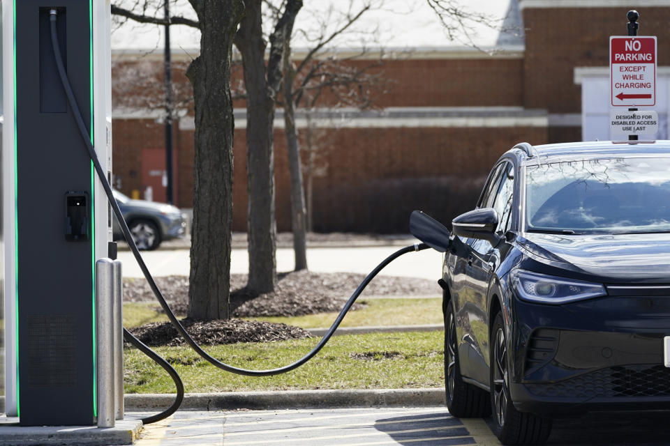 FILE - A Electrify America Charging Station for electric vehicle is seen at Woodfield Village Green in Schaumburg, Ill., Friday, April 1, 2022. German engineering company Siemens is making an investment in Electrify America, a Volkswagen division that includes a network of electric vehicle charging stations in North America. Electrify America said Tuesday, June 28, 2022, that Siemens is its first outside investor and will have a board seat. Siemens will contribute a low triple-digit million dollar amount, with media reports pegging it at more than $100 million. (AP Photo/Nam Y. Huh, File