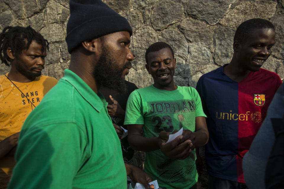 Haitian migrants wait in line outside the Mexican Commission for Migrant Assistance office to get the documents needed that allows them to stay in Mexico, in Tapachula, Thursday, June 20, 2019. The flow of migrants into southern Mexico has seemed to slow in recent days as more soldiers, marines, federal police, many as part of Mexico's newly formed National Guard, deploy to the border under a tougher new policy adopted at a time of increased pressure from the Trump administration. (AP Photo/Oliver de Ros)