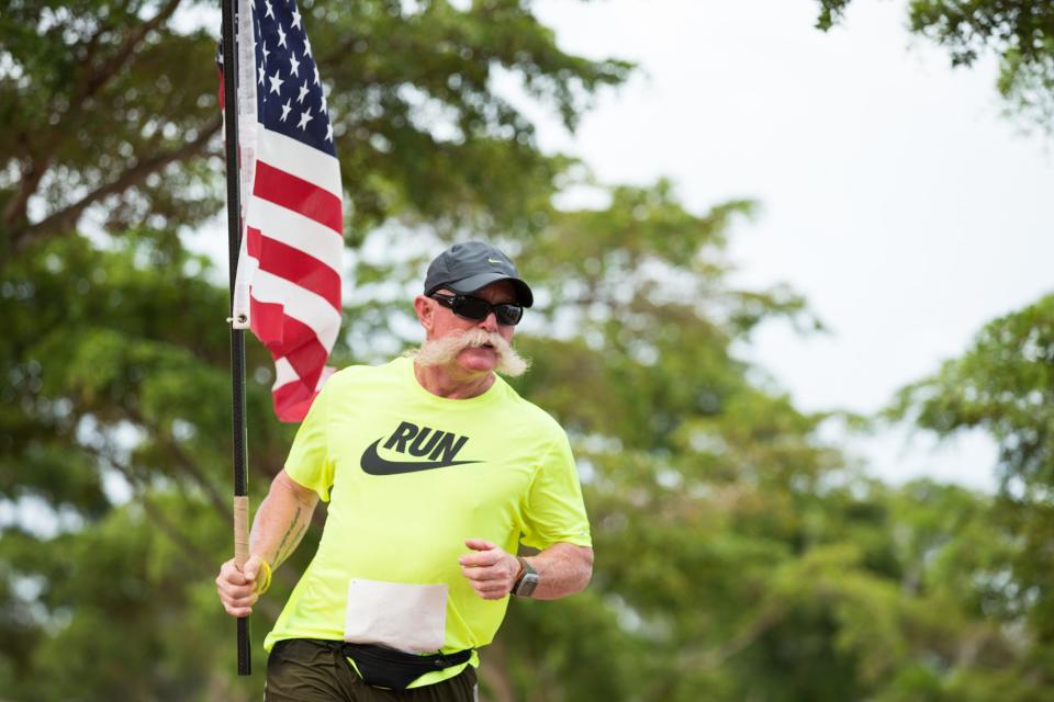 John Pyle had his trademark American flag in hand for the Nov. 9, 2013, Random Acts of Giving (R.A.G.) lap race at Payne Park in downtown Sarasota.