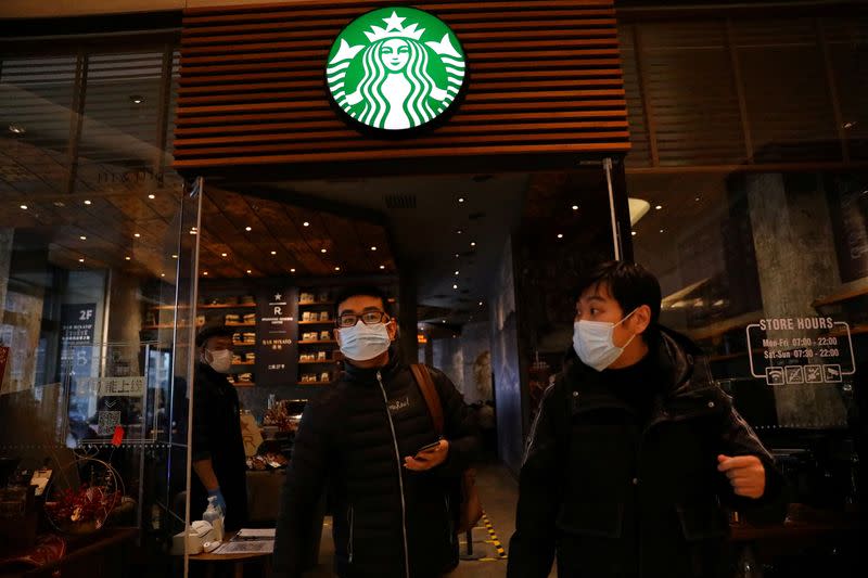 FILE PHOTO: People leave a Starbucks flagship store in Beijing