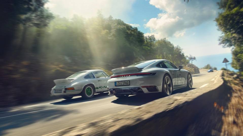 A 2023 Porsche 911 Sport Classic (right) shares the road with a 1970’s-era 911 Carrera RS 2.7. - Credit: Porsche AG