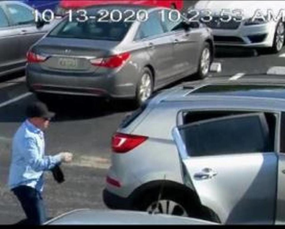 One of the would-be armed robbers jumps in the Kia Sportage to leave the Castle Apartments’ parking lot.