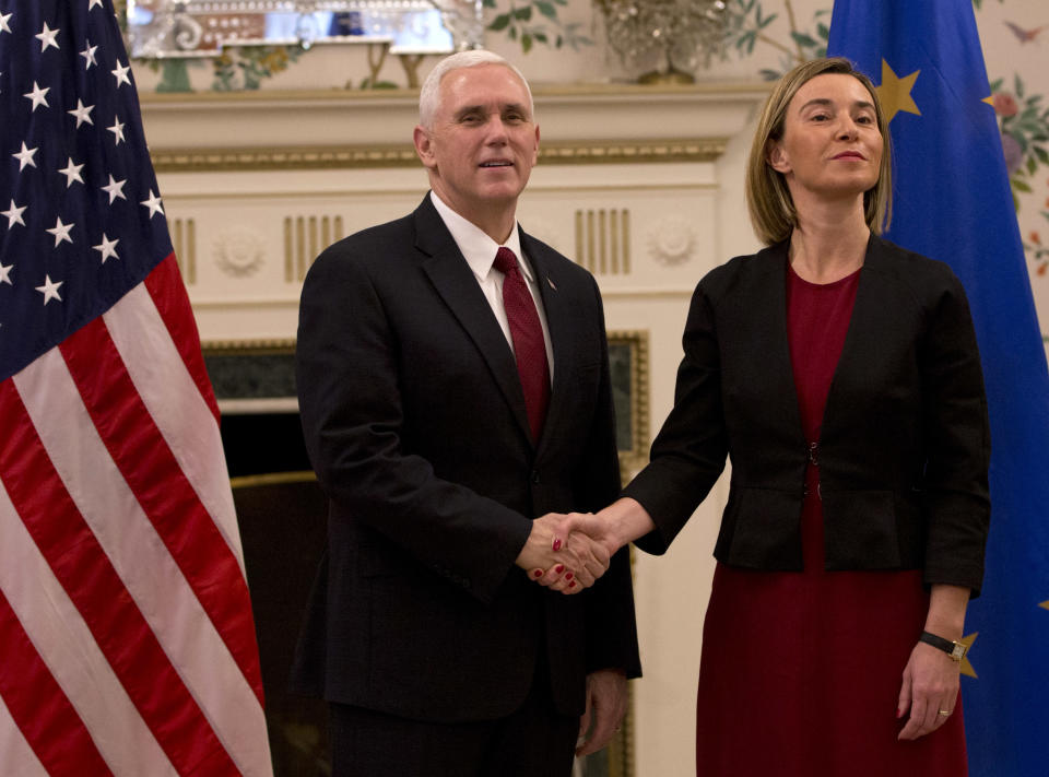 United States Vice President Mike Pence, left, shakes hands with European Union High Representative Federica Mogherini during a meeting at US ambassadors residence in Brussels on Monday, Feb. 20, 2017. U.S. Vice President Pence is currently on a two-day visit to meet with EU and NATO officials. (AP Photo/Virginia Mayo, Pool)