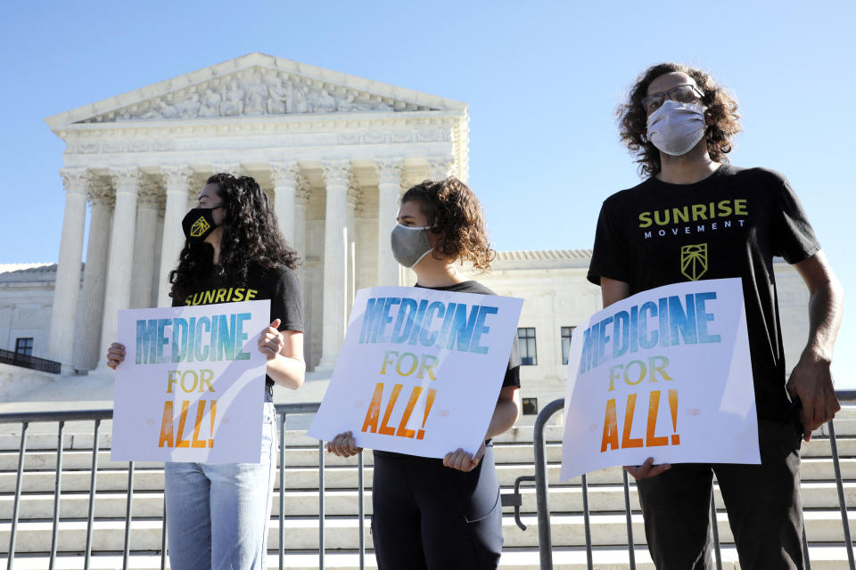 Demonstrators rally outside U.S. Supreme Court in Washington before in an argument on the Affordable Care Act on Nov. 10, 2020. (Yuri Gripas / Sipa via AP Images)