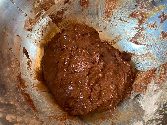 chocolate cookie dough sitting in a silver bowl