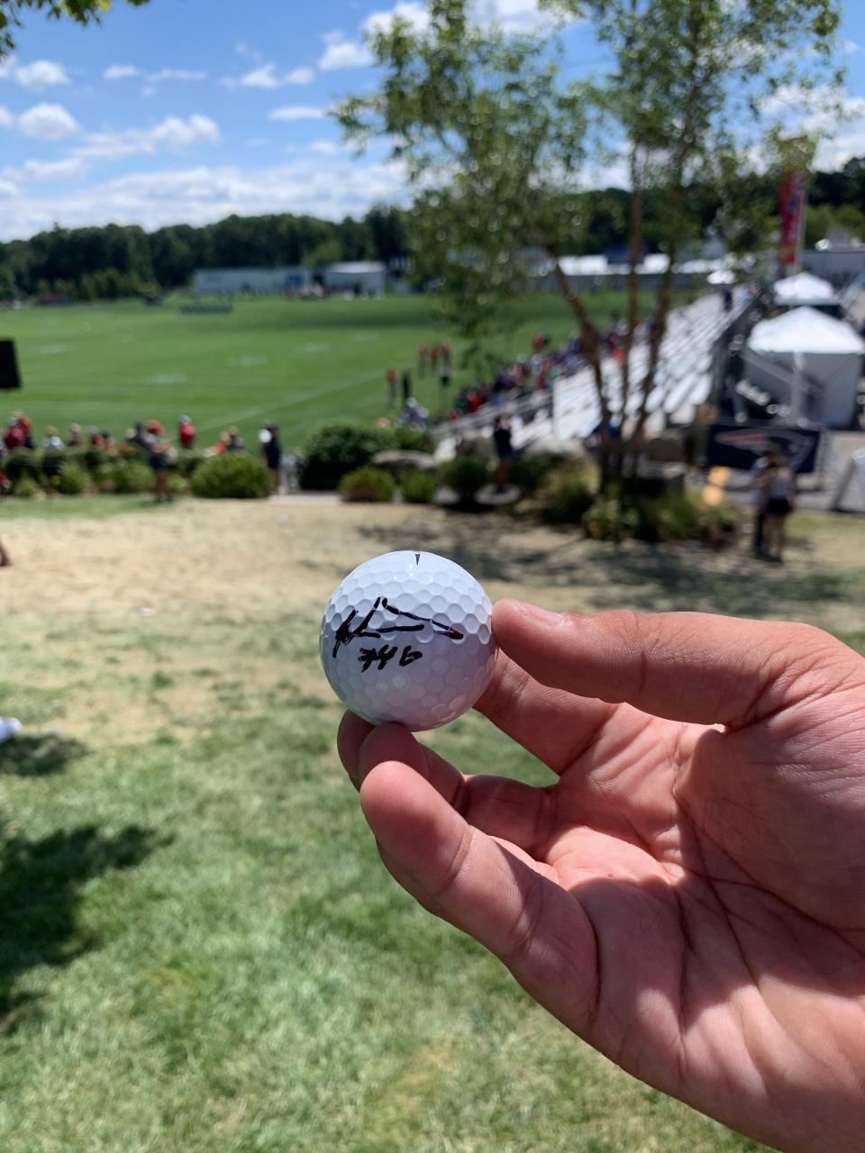 Matthew Cacciapaglia, of Franklin, shows off a golf ball he had signed by Patriots rookie Tyquan Thornton at training camp in Foxborough on Aug. 1, 2022.