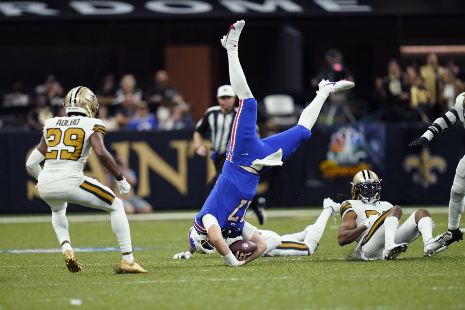 Buffalo Bills quarterback Josh Allen (17) is upended between New Orleans Saints cornerback Bradley Roby and cornerback Paulson Adebo (29) in the second half of an NFL football game in New Orleans, Thursday, Nov. 25, 2021. (AP Photo/Derick Hingle)