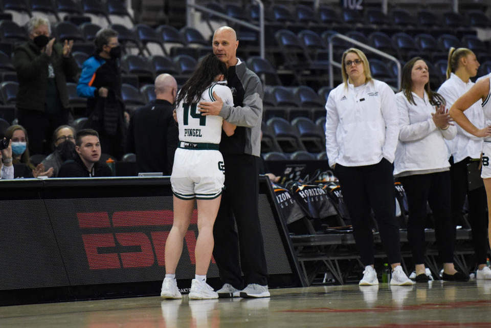 Green Bay's Kevin Borseth embraces Meghan Pingel in the closing seconds of a Horizon League tournament game in 2022. (James Black/Getty Images)