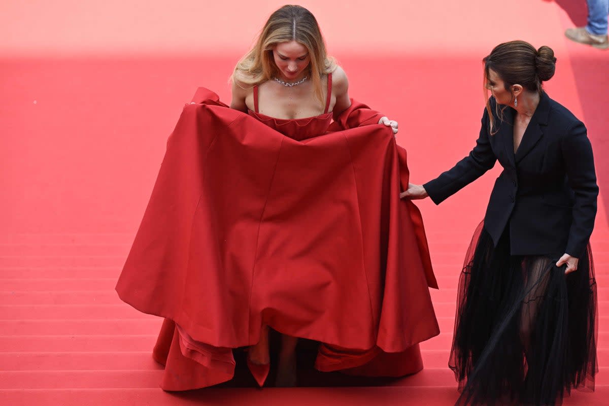 J.Law chose to trip  down the red carpet in a red Christian Dior gown and flip flops (AFP/Getty)