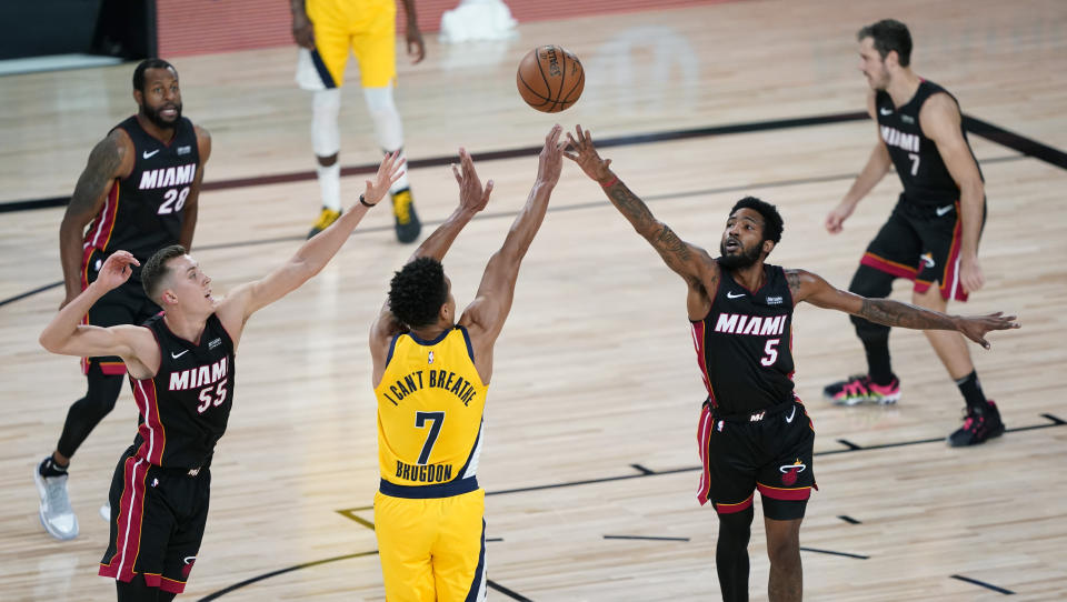 Indiana Pacers guard Malcolm Brogdon (7) shoots over Miami Heat forward Derrick Jones Jr. (5) during the second half of an NBA basketball first round playoff game, Tuesday, Aug. 18, 2020, in Lake Buena Vista, Fla. (AP Photo/Ashley Landis, Pool)