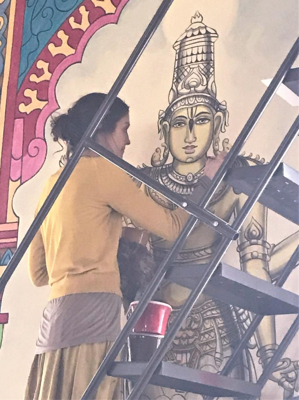 Karunavidravad Dasi works on a mural in the new Paranitya Narasimha Temple, housed in the former Our Lady of Lourdes Catholic Church in West Elmira.