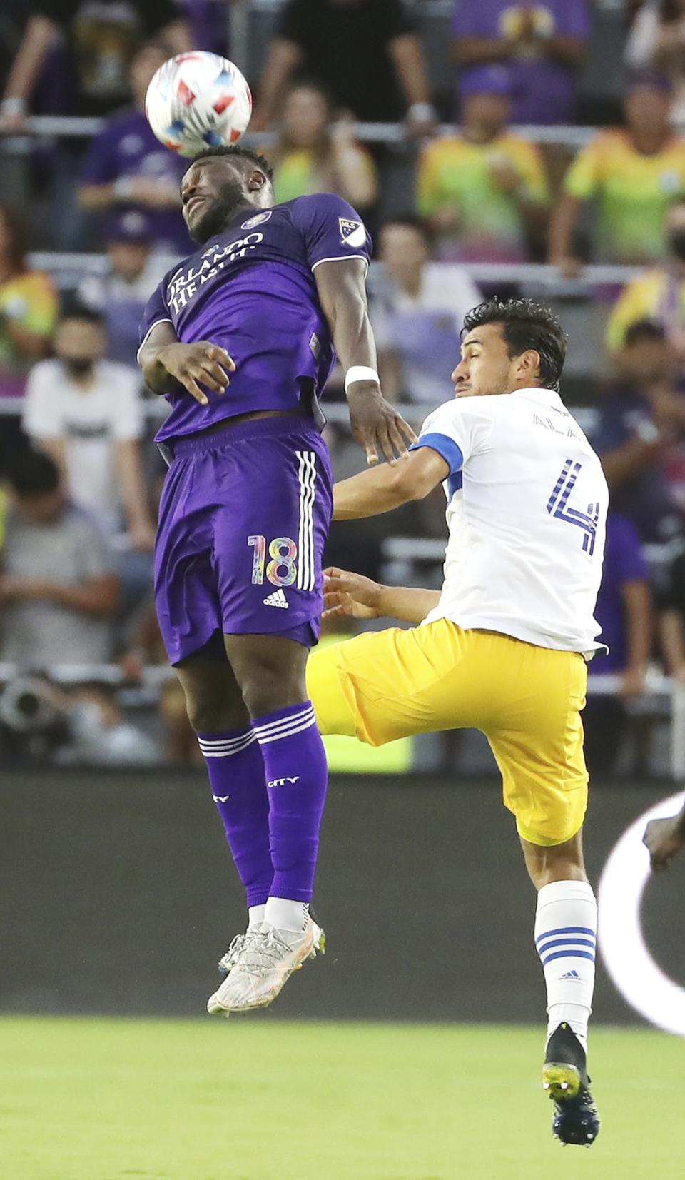 Orlando player Daryl Dike, left, leaps to head the ball beside San Jose player O. Alanis, right, during a MSL soccer match in Orlando, Fla., on Tuesday, June 22, 2021. (Stephen M. Dowell /Orlando Sentinel via AP)