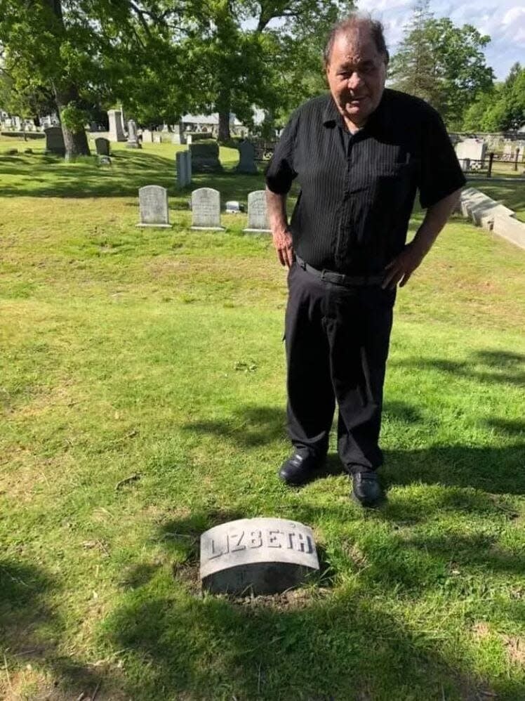 Len Rebello stands at the grave of Lizzie Borden in Oak Grove Cemetery in Fall River.