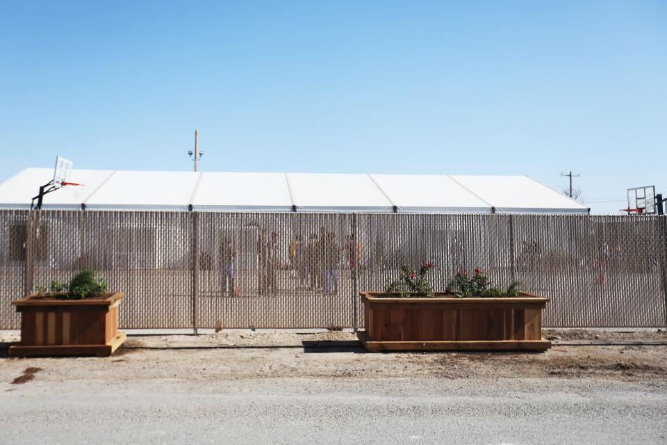 Migrant children play outside at a shelter for unaccompanied minors on April 9, 2021, in Pecos, Texas. The property is owned by Target Hospitality. It was formally being used by oil field workers for lodging while at a job work site. It is now housing migrant children.