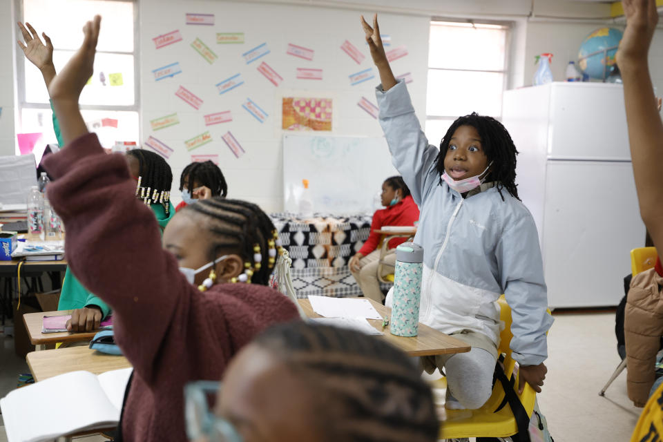 Zeniyha Howard, 10, of Decatur, Ga., raises their hand during a math lesson at the Kilombo Academic and Cultural Institute, Tuesday, March 28, 2023, in Decatur, Ga. (AP Photo/Alex Slitz)