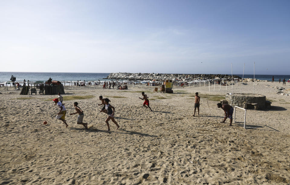 Youths play soccer at Camuri Chico beach in Vargas state, Venezuela, Friday, March 1, 2019. It’s carnival season in Venezuela, though many citizens are not in a mood to party, as the country is gripped by a political crisis that pits leader Nicolas Maduro against Juan Guaido, the opposition chief who was in Paraguay on Friday as part of a campaign to build international pressure on his rival to quit. (AP Photo/Eduardo Verdugo)