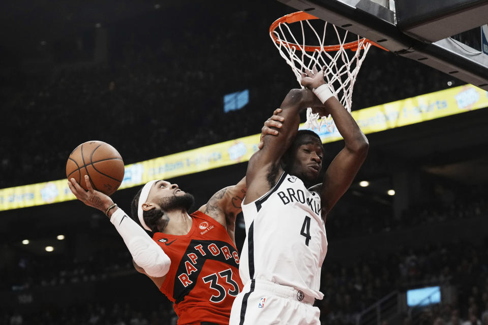 Toronto Raptors guard Gary Trent Jr. (33) shoots over Brooklyn Nets guard Edmond Sumner (4) during the first half of an NBA basketball game Wednesday, Nov. 23, 2022, in Toronto. (Chris Young/The Canadian Press via AP)