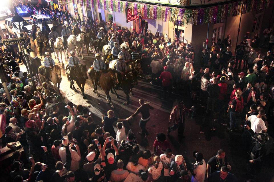 File - In this March 9, 2011 file photo, police on horseback and foot clear out the crowds on Bourbon Street at midnight for the end of Mardi Gras festivities in New Orleans. The final weekend of Mardi Gras season in New Orleans has begun with a warning from police that crowds won't be tolerated as the city fights to stop the spread of the coronavirus. Police chief Shaun Ferguson noted Friday, Feb. 12, 2021, that bars throughout the city were being ordered to close through Fat Tuesday. And he said police will man barricades limiting pedestrian traffic on Bourbon Street to people who live or work there, hotel guests, and restaurant patrons. T (AP Photo/Gerald Herbert, File)
