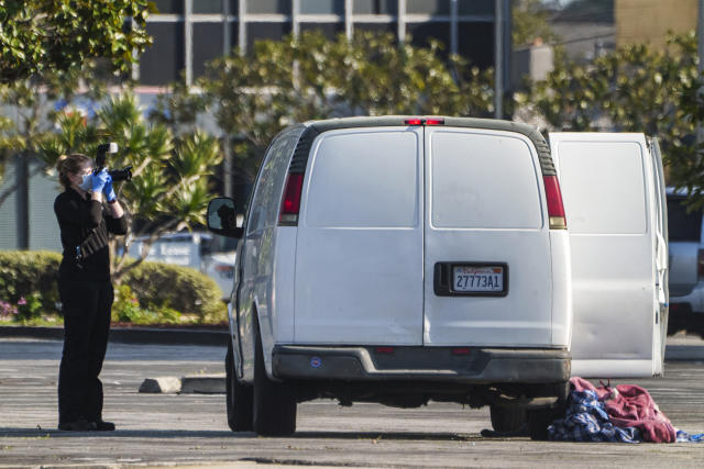 A forensic photographer takes pictures of a van's window and its contents in Torrance, Calif., Sunday, Jan. 22, 2023. A mass shooting took place at a dance club following a Lunar New Year celebration, setting off a manhunt for the suspect. (AP Photo/Damian Dovarganes)