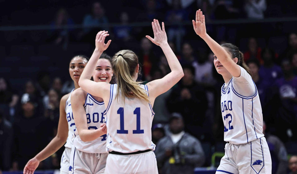 Springboro players Morgan Meek (11), Bryn Martin (12), Aniya Trent (30) and Chloe Downing (24) celebrate after their win against Pickerington Central in the OHSAA state tournament Friday, March 15, 2024.