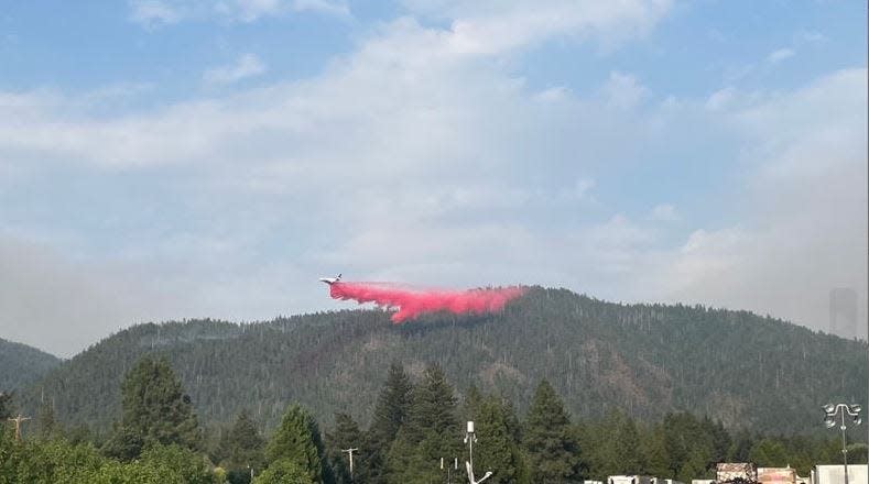 An airplane drops retardant on blazes burning in late August the Six Rivers National Forest in north Del Norte County.