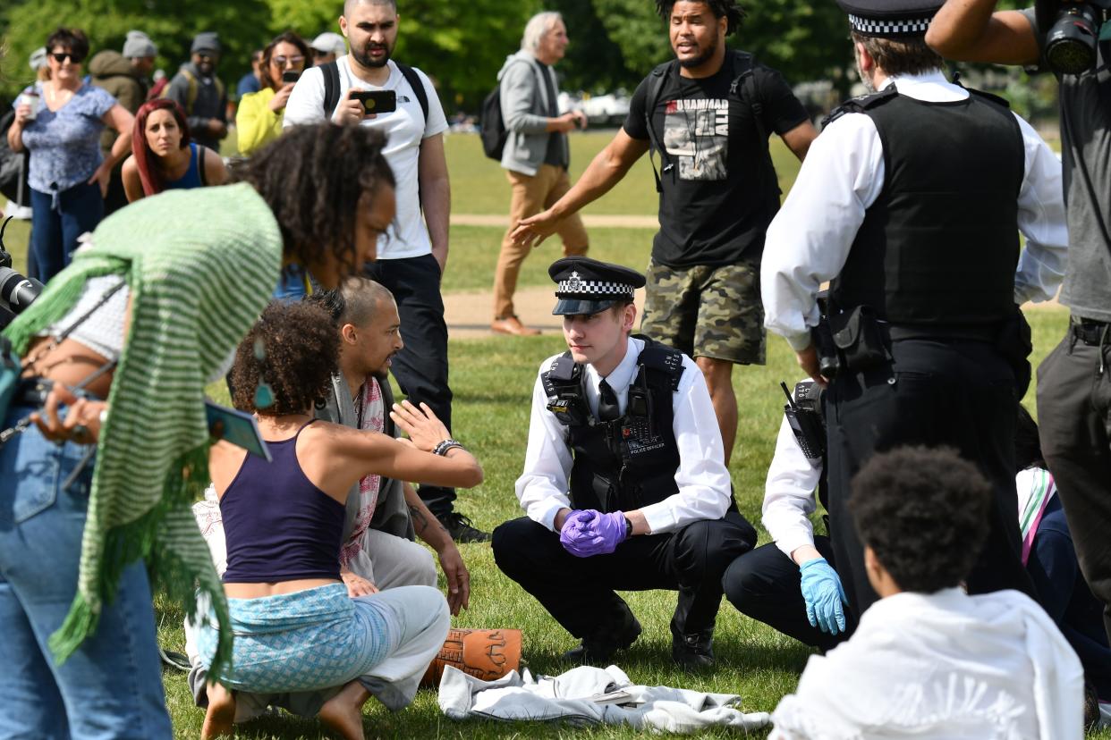 Police officers disperse people who are gathered in Hyde Park in London on May 16, 2020, following an easing of lockdown rules in England during the novel coronavirus COVID-19 pandemic. - People are being asked to 