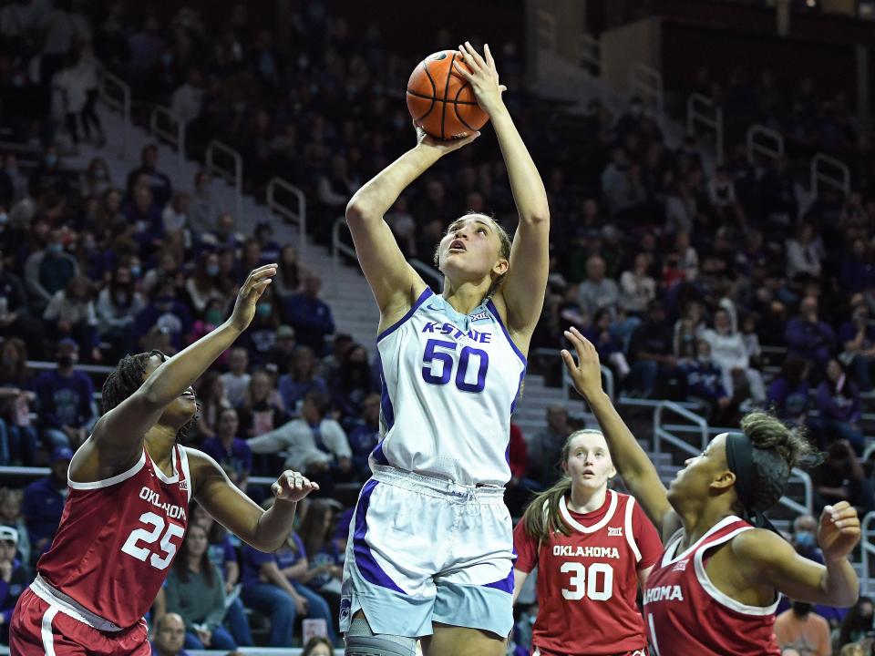 Kansas State center Ayoka Lee (50) puts up a shot between Oklahoma's Madi Williams (25) and Nevaeh Tot (1) while Taylor Robertson (30) looks on Sunday at Bramlage Coliseum. Lee broke the NCAA single game scoring record with 61 points in the Wildcats' 94-65 victory.