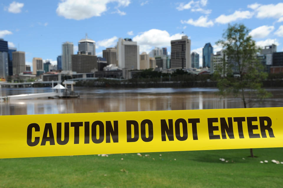 BRISBANE, AUSTRALIA - JANUARY 29: Council caution tape is seen to restrict access to the Brisbane river at South Bank as parts of southern Queensland experiences record flooding in the wake of Tropical Cyclone Oswald on January 29, 2013 in Brisbane, Australia. The river in the Brisbane CBD is expected to peak at 2.3 metres today - lower than the 2.6 metre peak predicted - but is still likely to flood low-lying properties and businesses. The flood crisis has claimed four lives so far, with the city of Bundaberg, Queensland faces the worst flooding in its history. (Photo by Matt Roberts/Getty Images)