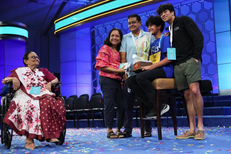 Dev Shah, 14, holds the trophy accompanied by his father Deval Shah, his mother Nilam Shah, his brother Neil Shah and his grandmother Vinaben Shah (REUTERS)