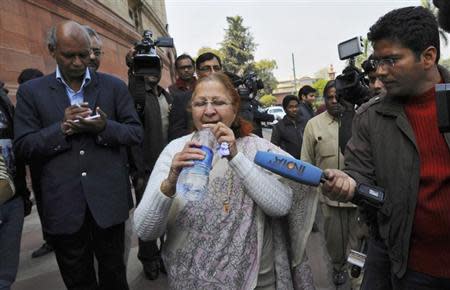 Sumitra Mahajan, a parliamentarian and a leader of Bharatiya Janata Party (BJP), drinks water after she rushed out of the parliament in New Delhi February 13, 2014. REUTERS/Adnan Abidi