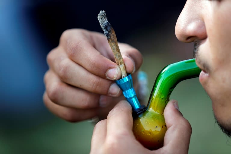 An Israeli smokes a marijuana joint in Jerusalem on April 20, 2017 during a rally to express defiance of current laws