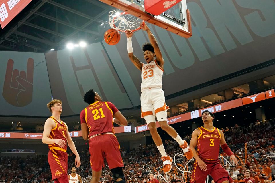 Texas forward Dillon Mitchell slams a dunk over Iowa State defenders Aljaz Kunc, Tamin Lipsey and Osun Osunniyi during Tuesday night's win over the Cylones at Moody Center. The Longhorns are tied for the Big 12 lead with Kansas with three games left in the regular season.