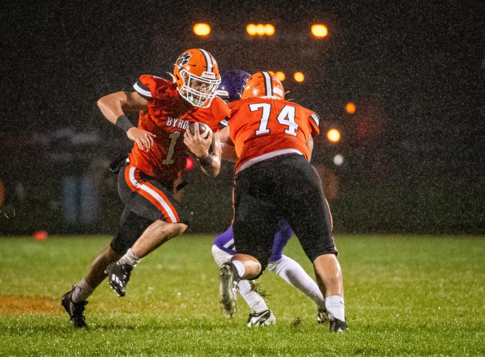 Byron's Brayden Knoll runs for a touchdown while Nolan Brass (No. 74) opens up a hole during their game against Dixon on Friday, Oct. 13, 2023, in Byron.