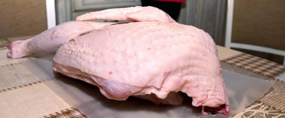 Raw uncooked turkey on table