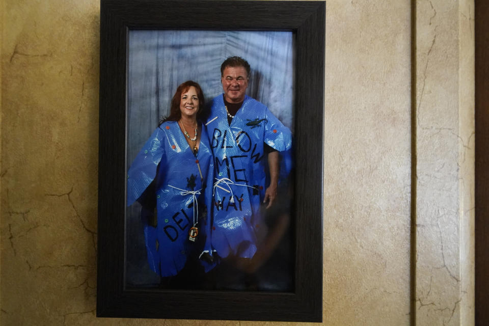 A framed photo of Dewana Young and her husband Pete is seen, as they are dressed in Halloween costumes, as hurricanes Laura and Delta, in the aftermath of the two storms, in Grand Lake, La., Friday, Dec. 4, 2020. (AP Photo/Gerald Herbert)