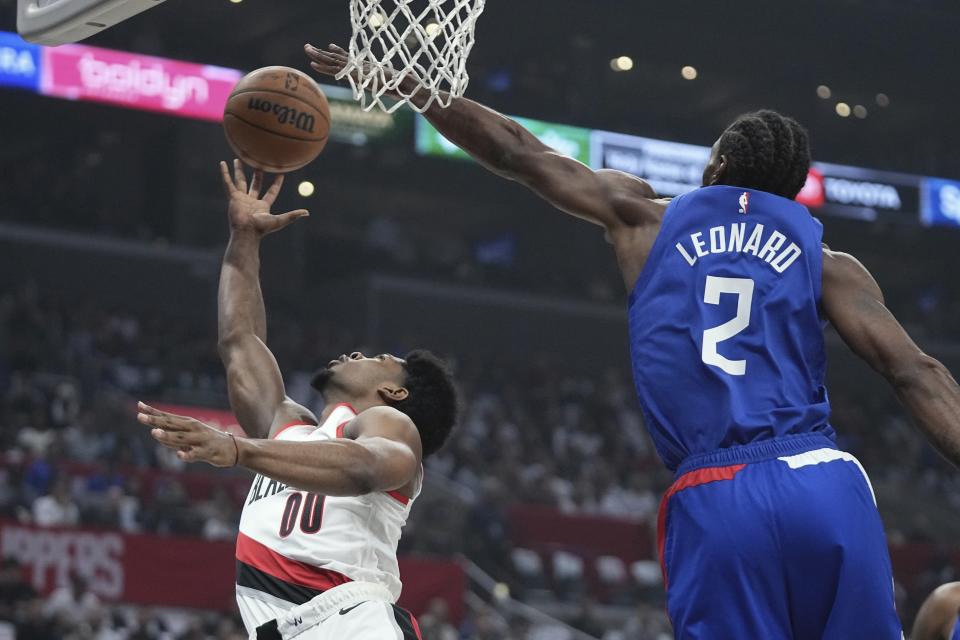 Portland Trail Blazers guard Scoot Henderson, left, shoots as Los Angeles Clippers forward Kawhi Leonard defends during the first half of an NBA basketball game Wednesday, Oct. 25, 2023, in Los Angeles. (AP Photo/Mark J. Terrill)