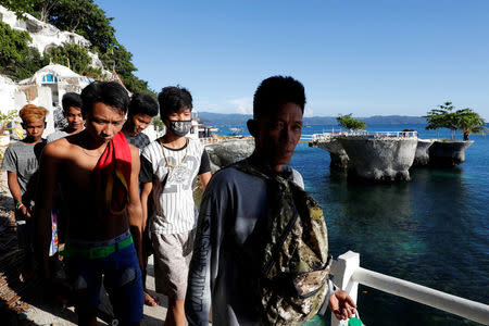 A demolition crew leave West Cove resort after a day's work to dismantle the resort, two days before the temporary closure of the holiday island Boracay in the Philippines April 24, 2018. REUTERS/Erik De Castro