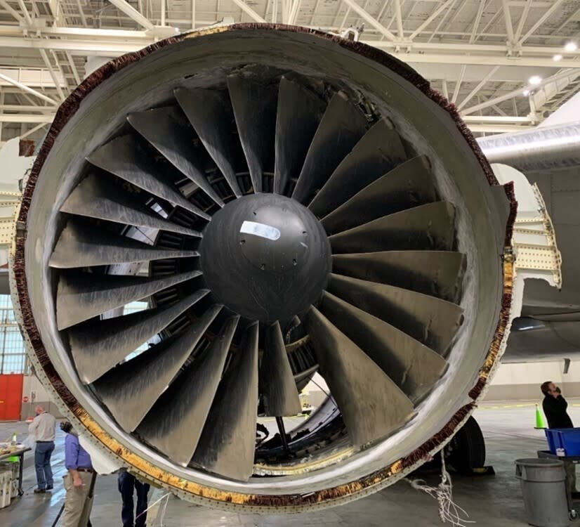 This photo provided by The National Transportation Safety Board shows the damaged engine of United Airlines Flight 328. Federal safety officials are updating their investigation into the engine failure on the United Airlines plane that sent parts of the engine housing raining down on Denver-area neighborhoods last month. The National Transportation Safety Board said Friday, March 5, 2021 that a microscopic exam confirmed that a fan blade that snapped off had telltale signs of fatigue — tiny cracks caused by wear and tear. (The National Transportation Safety Board via AP)