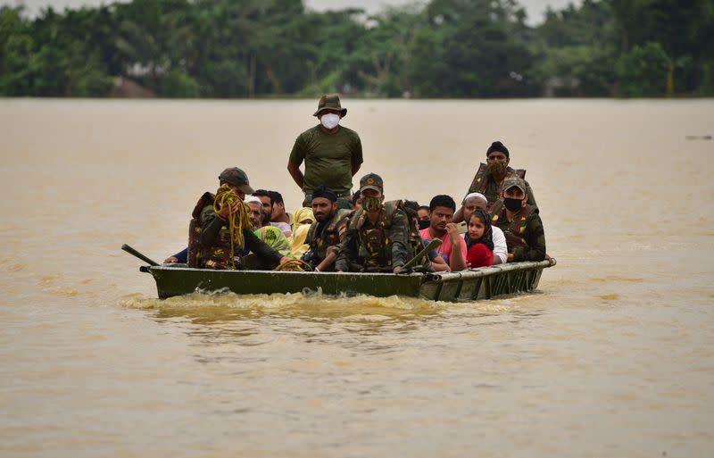 FILE PHOTO: Indian Army soldiers evacuate people from flooded area to a safer place after heavy rains at a village in Hojai district