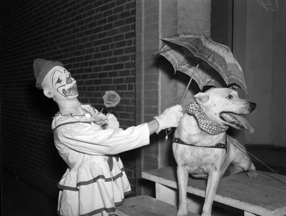 Aug. 5, 1940: Recreation Department circus. Bob Totten, clown, and “Toughie,” dog, seen performing an act using an umbrella.