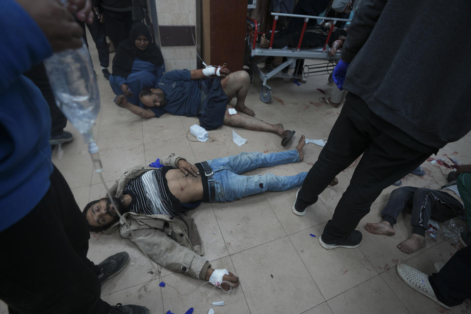 Palestinians wounded in the Israeli bombardment of the Gaza Strip are brought to Al Aqsa hospital in Deir al Balah, Gaza Strip, Sunday, Jan. 7, 2024. (AP Photo/Adel Hana)
