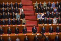 Chinese President Xi Jinping, second row at center, and other Chinese leaders and delegates stand during the closing session of China's National People's Congress (NPC) at the Great Hall of the People in Beijing, Thursday, May 28, 2020. China's ceremonial legislature has endorsed a national security law for Hong Kong that has strained relations with the United States and Britain. (AP Photo/Mark Schiefelbein)