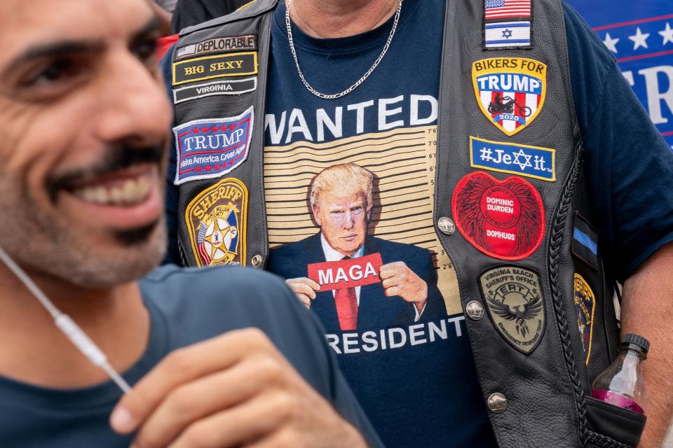A protester wears MAGA merchandise.